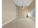 Spacious carpeted bedroom with ceiling fan, natural light, and beige walls at 5605 Cary Glen Blvd, Cary, NC 27519