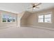 Large bedroom with neutral color scheme, dormer window, and ceiling fan at 5605 Cary Glen Blvd, Cary, NC 27519