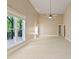 Large bedroom with private deck, carpet, high ceilings, and neutral paint at 5605 Cary Glen Blvd, Cary, NC 27519