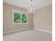 Bedroom features a chandelier and a large window with natural light at 5605 Cary Glen Blvd, Cary, NC 27519