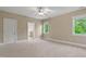 Bedroom with windows, carpet floor, a ceiling fan and access to the ensuite bathroom at 5605 Cary Glen Blvd, Cary, NC 27519