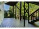 Large deck offers an outdoor living space surrounded by mature trees at 5605 Cary Glen Blvd, Cary, NC 27519