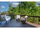 Outdoor deck with comfortable seating and a view of the surrounding lush trees at 5605 Cary Glen Blvd, Cary, NC 27519