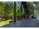 View of the backyard from the deck with wood supports and stairs at 5605 Cary Glen Blvd, Cary, NC 27519