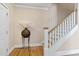 Home entryway with hardwood floors, white trim, staircase, and decorative vase at 5605 Cary Glen Blvd, Cary, NC 27519