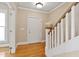 Bright foyer with hardwood floors, white trim, and a staircase leading to the upper level at 5605 Cary Glen Blvd, Cary, NC 27519