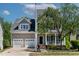 Charming two-story home featuring a porch, well-manicured lawn, and an attached two-car garage at 5605 Cary Glen Blvd, Cary, NC 27519