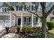 Charming front porch with white columns, brick steps, and inviting rocking chairs at 5605 Cary Glen Blvd, Cary, NC 27519