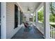 Front porch featuring black rocking chairs, a ceiling fan, and white railings at 5605 Cary Glen Blvd, Cary, NC 27519