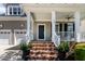 Inviting front porch with brick steps, white railings, and a view of the neighborhood at 5605 Cary Glen Blvd, Cary, NC 27519