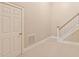 Hallway featuring carpeted floors, a white door and staircase at 5605 Cary Glen Blvd, Cary, NC 27519