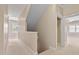 Upstairs hallway with neutral carpet leading to the various bedrooms at 5605 Cary Glen Blvd, Cary, NC 27519