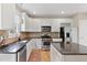 Well-lit kitchen with white cabinets, stainless steel appliances, and a functional center island at 5605 Cary Glen Blvd, Cary, NC 27519