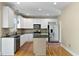 Well-lit kitchen with white cabinets, stainless steel appliances, and a functional center island at 5605 Cary Glen Blvd, Cary, NC 27519