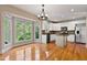 Bright kitchen with hardwood floors, white cabinetry, and stainless steel appliances at 5605 Cary Glen Blvd, Cary, NC 27519