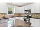 Well-lit kitchen with white cabinets, stainless steel appliances, and a functional center island at 5605 Cary Glen Blvd, Cary, NC 27519