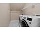 Laundry room includes modern washer and dryer with shelving at 5605 Cary Glen Blvd, Cary, NC 27519