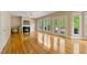 Bright living room with hardwood floors, fireplace, and multiple windows showcasing outdoor views at 5605 Cary Glen Blvd, Cary, NC 27519