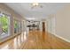 Open living room with hardwood floors, a kitchen view, and glass doors to outdoor space at 5605 Cary Glen Blvd, Cary, NC 27519