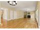 Spacious living room featuring a fireplace, ceiling fan, and hardwood floors at 5605 Cary Glen Blvd, Cary, NC 27519