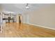 Open living room with hardwood floors, a view into the kitchen, and neutral walls at 5605 Cary Glen Blvd, Cary, NC 27519