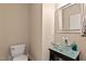 Modern powder room featuring a glass bowl sink and neutral wall colors at 5605 Cary Glen Blvd, Cary, NC 27519