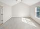Open bedroom with vaulted ceilings and window at 62 Sailfish Ct, Clayton, NC 27520