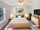 Bright bedroom with a ceiling fan, a large bed, a nightstand, and a flatscreen tv at 62 Sailfish Ct, Clayton, NC 27520