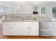 Eat-in kitchen with stainless steel dishwasher and views into the living room at 62 Sailfish Ct, Clayton, NC 27520