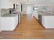 Bright kitchen with stainless steel appliances, stone countertops and hardwood floors at 62 Sailfish Ct, Clayton, NC 27520