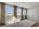 Bright bedroom with large windows providing natural light, complemented by neutral curtains and bedding at 714 Andrade Dr, Fuquay Varina, NC 27526