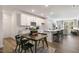 Open-concept kitchen with white cabinets, stainless steel appliances, large island, and wood floors at 714 Andrade Dr, Fuquay Varina, NC 27526