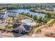 Aerial view of community clubhouse, pool, and surrounding townhomes near a tranquil lake at 717 Silo Park Dr, Wake Forest, NC 27587