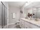 Elegant bathroom featuring double sinks with granite countertops and a glass-enclosed shower at 717 Silo Park Dr, Wake Forest, NC 27587