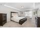 Comfortable bedroom features tray ceiling, carpet, and natural light from a large window at 717 Silo Park Dr, Wake Forest, NC 27587