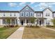 Inviting townhome exterior features a landscaped yard and charming front porch at 717 Silo Park Dr, Wake Forest, NC 27587