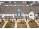 Aerial view of townhomes featuring well-manicured lawns and inviting front porches and walkways at 717 Silo Park Dr, Wake Forest, NC 27587