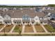 Aerial view of townhomes with well-maintained lawns, sidewalks, and inviting front porches at 717 Silo Park Dr, Wake Forest, NC 27587