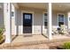 Inviting front porch with a stylish entrance door and seating area, perfect for relaxing outdoors at 717 Silo Park Dr, Wake Forest, NC 27587