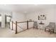 Upstairs hallway with seating area and railing overlooking the lower level at 717 Silo Park Dr, Wake Forest, NC 27587