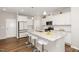 Bright, modern kitchen with white cabinets, granite countertops, and stainless steel appliances at 717 Silo Park Dr, Wake Forest, NC 27587