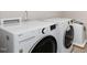 Efficient laundry room featuring a front loading washer, dryer, and utility sink for convenience at 717 Silo Park Dr, Wake Forest, NC 27587