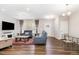 Spacious living room with hardwood floors, comfortable seating, and natural light at 717 Silo Park Dr, Wake Forest, NC 27587