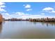 Scenic view of a serene pond surrounded by trees under a blue sky at 717 Silo Park Dr, Wake Forest, NC 27587