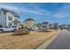 Street view in a neighborhood featuring well-maintained sidewalks, common greenspace, and attractive landscaping at 717 Silo Park Dr, Wake Forest, NC 27587