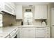 Well-maintained kitchen features white cabinets, modern appliances, and a bright window over the sink at 732 Westview Ct, Nashville, NC 27856