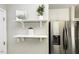 Pantry area offers extra shelving and storage next to a stainless steel refrigerator at 732 Westview Ct, Nashville, NC 27856