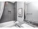 Modern bathroom features sleek gray tiles, white fixtures, and minimalist design for a clean aesthetic at 755 Bachelor Gulch Way, Apex, NC 27523