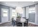 The dining room with a gray walls, white trim, and a white table with black chairs at 755 Bachelor Gulch Way, Apex, NC 27523