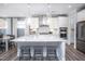 A well-appointed kitchen featuring sleek countertops, stainless steel appliances, and stylish pendant lighting at 755 Bachelor Gulch Way, Apex, NC 27523